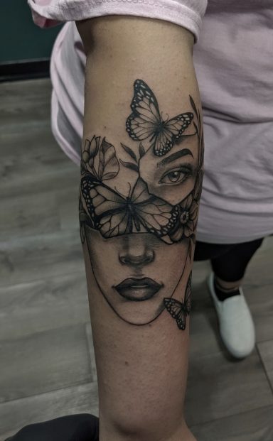 Woman's face with butterflies